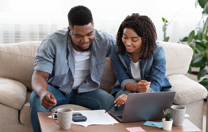 Smiling couple looking at documents together.