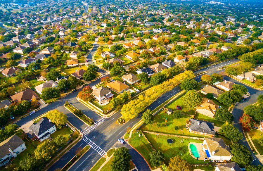 Above Autumn Colors Aerial on Suburbs Homes in Austin , Texas. Looking down Birds Eye View on Suburbia Homes in Austin , Texas a Colorful Residential Area in Fall Autumn