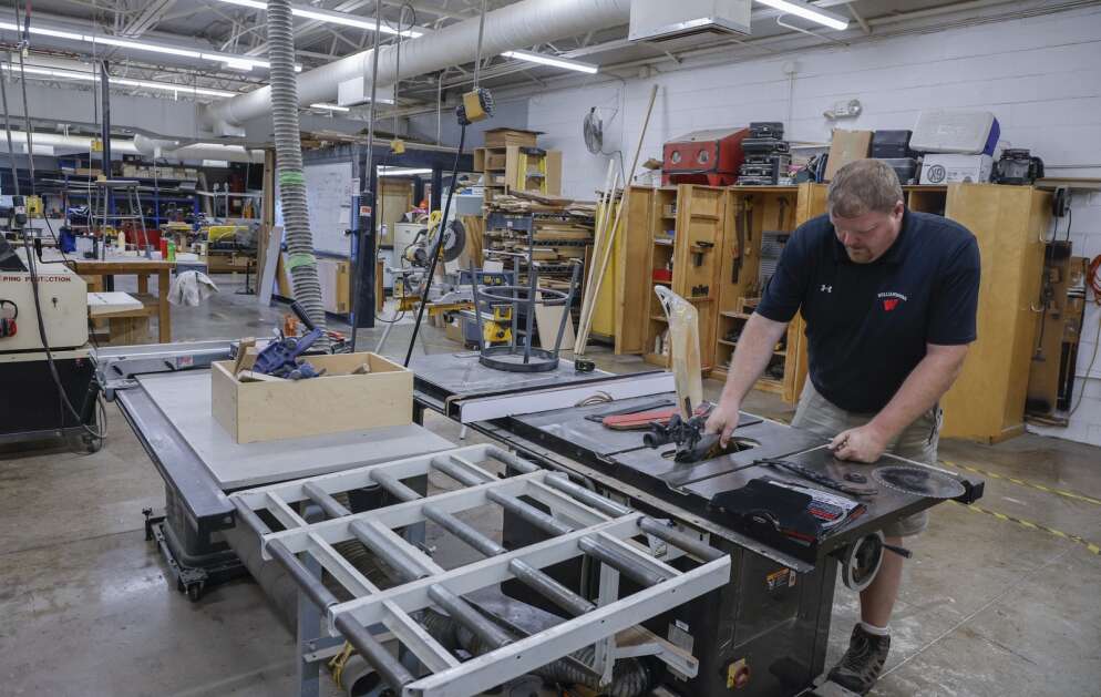 Industrial technology teacher Kevin Wilkinson replaces the blade Tuesday in a table saw in the wood shop at Williamsburg Junior/Senior High School. The Williamsburg Community School District, one of three Eastern Iowa school systems asking voters this November to approve general obligation bonds, will seek approval of a $22.3 million referendum. The bond would provide funds to build an addition to the elementary school and make improvements to the junior/senior high school building, including updates to classrooms, improvements to the heating and cooling system and the creation of additional space to accommodate the instrumental music program. (Jim Slosiarek/The Gazette)