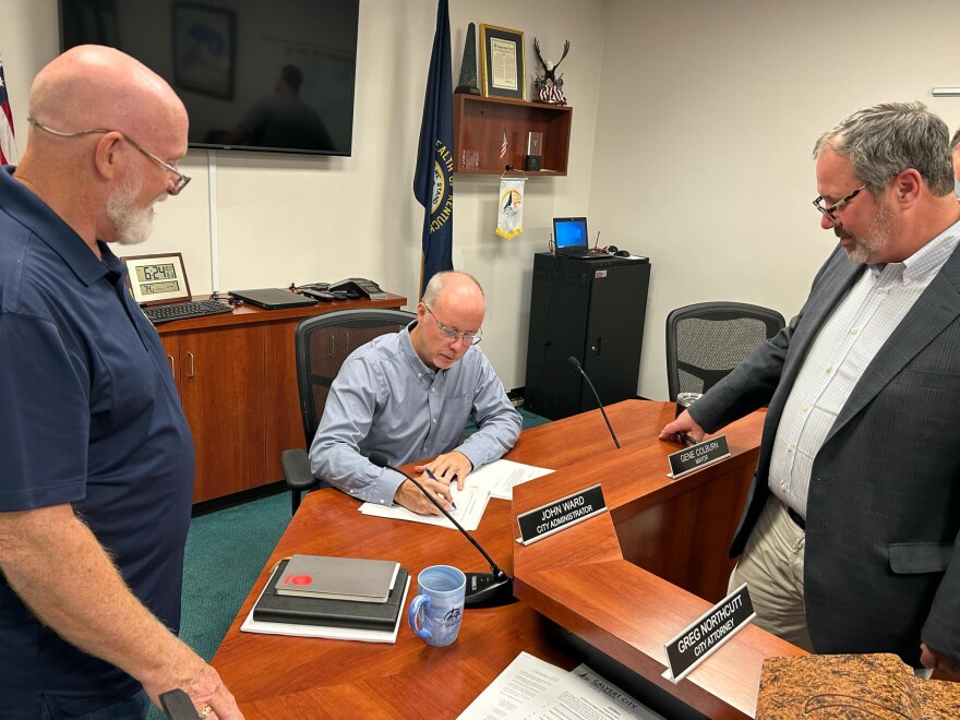 Calvert City Mayor Gene Colburn signs the resolution to provide Churchill Down with tax-exempt bonds to building a new horse race gaming center.