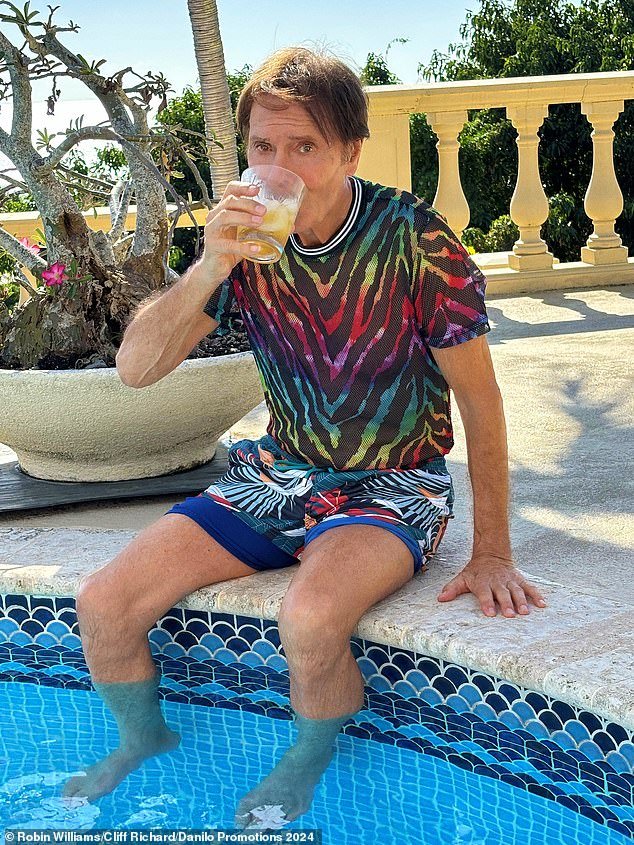 The pop veteran, 83, took his fans on a Summer Holiday for his latest annual poses, sipping on cocktails and posing for a fun snap with a dolphin water feature