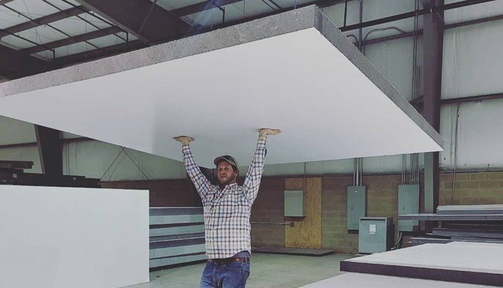 MDLR Brands employee shows lightweight of LiteSIP roof panel