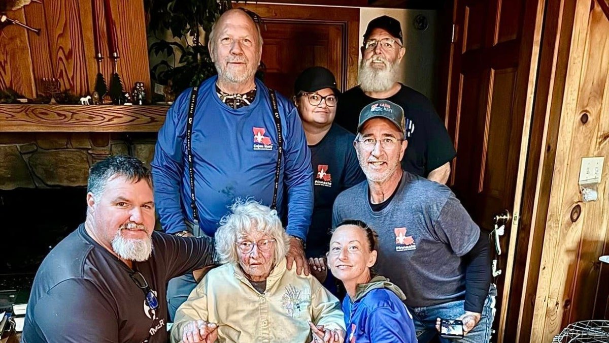 Cajun Navy 2016 volunteers stand next to Ms. Jo Jane in her home