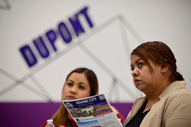 Maria Trujillo, left, and her sister Victoria Trujillo, listen in during a town hall meeting to discuss Adams County School District 14's bond and mill levy that will be on the November ballot, on Tuesday, Sept. 24, 2024, at Dupont Elementary in Commerce City, Colorado. The two are parents of students in the district. (Photo by Hyoung Chang/The Denver Post)