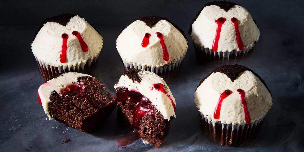 chocolate cupcakes topped with white icing and red lines