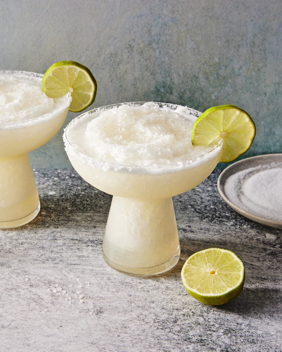 frozen margarita with a salt rim and lime wedge