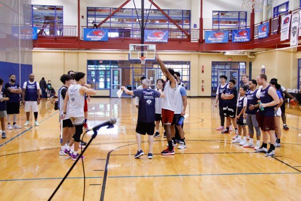 Participants line up as they are divided into teams by...