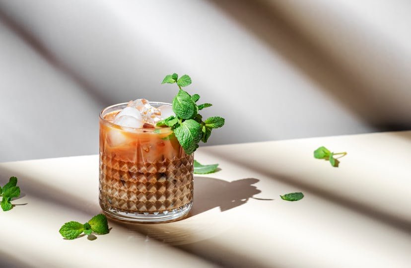 Mint White Russian cocktail drink with vodka, coffee liqueur, mint schnapps, cream and ice cubes 