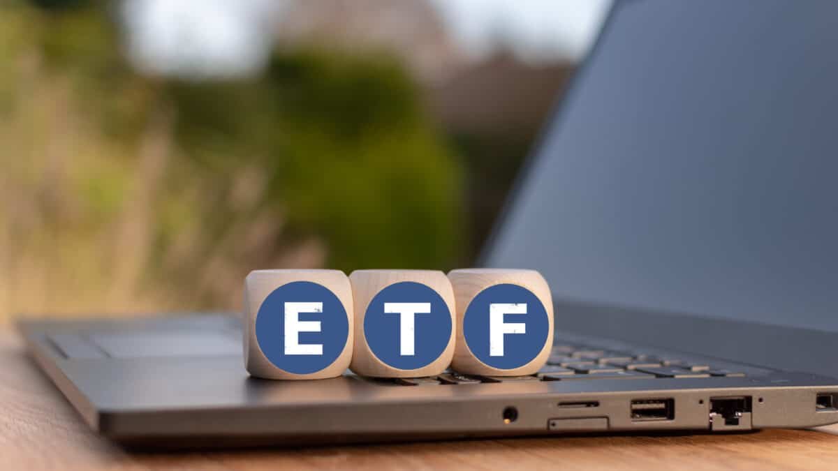 Cubes placed on a Notebook with the letters "ETF" which stands for "Exchange traded funds".