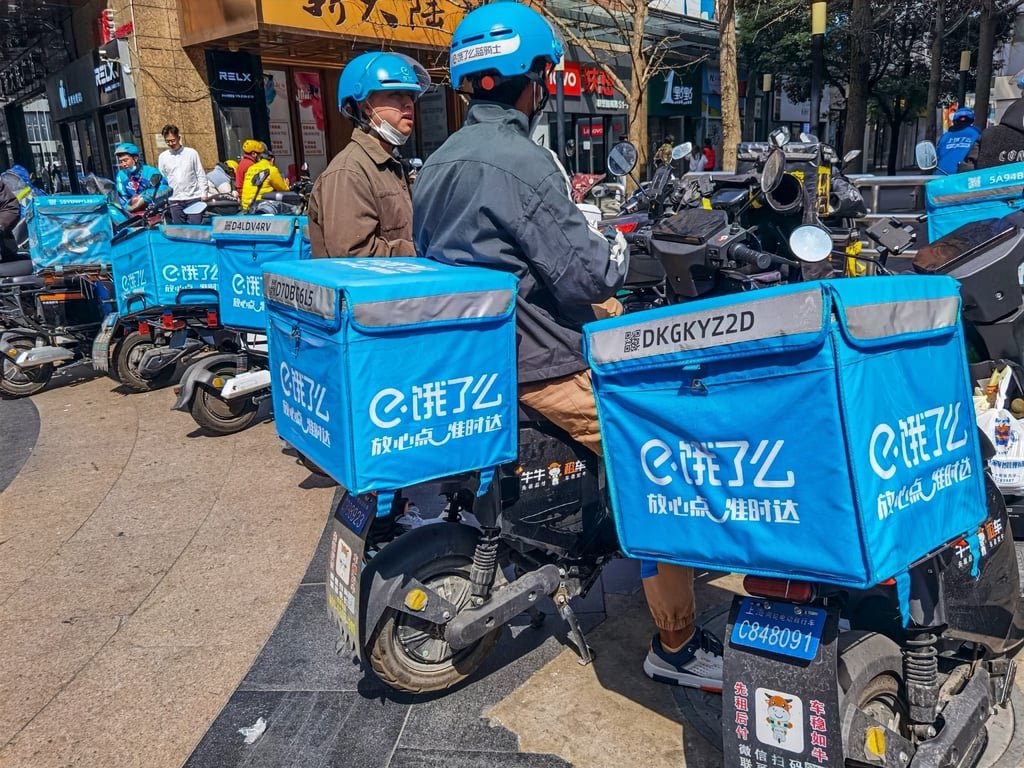 Ele.me food delivery riders wait for orders on a street in Beijing. Photo: Shutterstock Ele.me food delivery riders wait for orders on a street in Beijing. Photo: Shutterstock