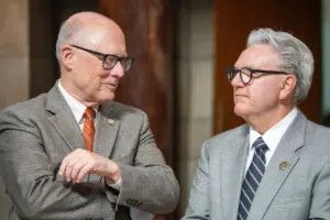 Speaker of the Nebraska Legislature John Arch, left, talks with former Speaker Jim Scheer of Norfolk. Scheer now serves on the University of Nebraska Board of Regents. June 6, 2025. (Zach Wendling/Nebraska Examiner)
