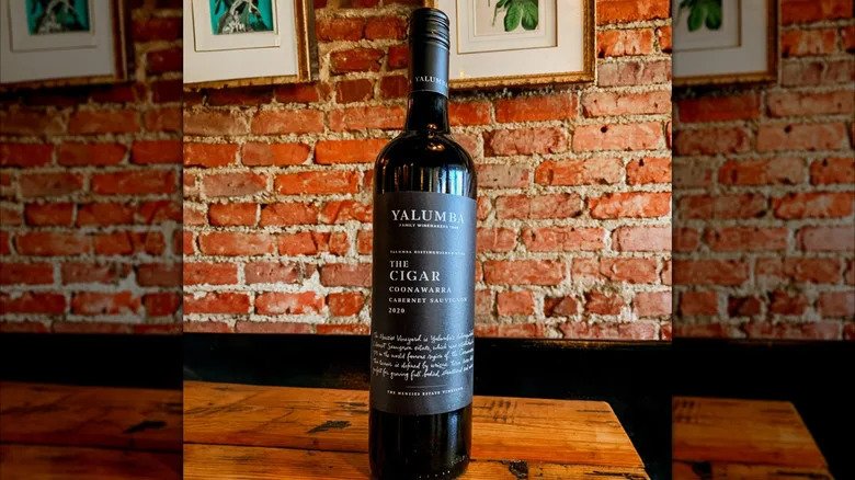 Bottle of red wine Yalumba The Cigar Cabernet Sauvignon with brick wall background