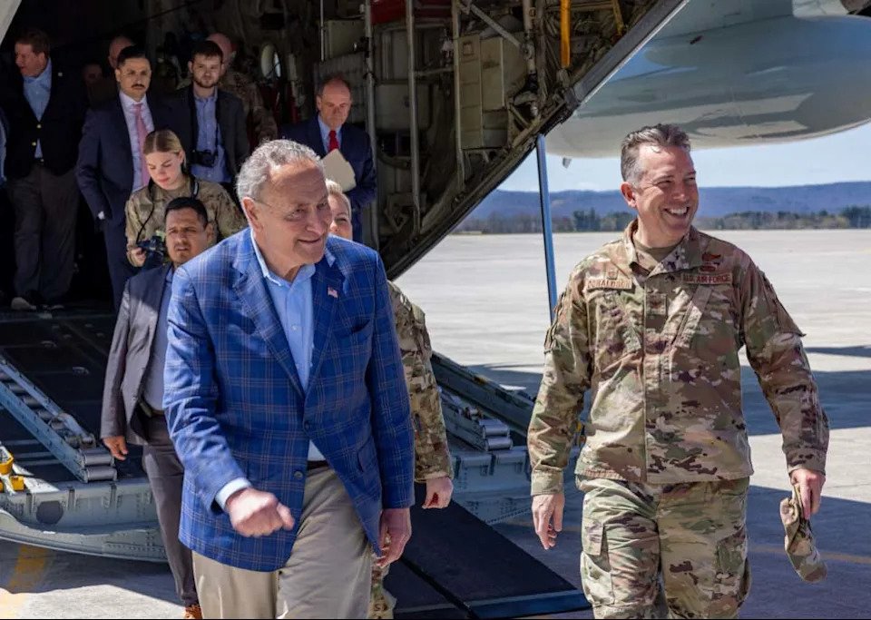 New York Senator Charles Schumer, the Senate Majority Leader, exits and LC-130H ski-equipped Hercules aircraft flown by the New York Air National Guard's 109th Airlift Wing during a visit to Stratton Air National Guard Base outside Schnectady, New York on April 22, 2024. To his left is Col. Robert Donaldson, the wing's commander. Schumer is calling on the Air Force to finance new versions of the planes, the largest in the world which can land on ice and snow, to replace the fleet which are 30 to 50 years old.