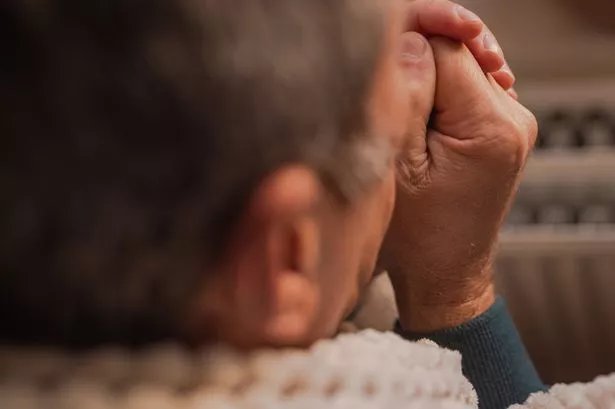 Picture of an older person using a blanket to keep warm