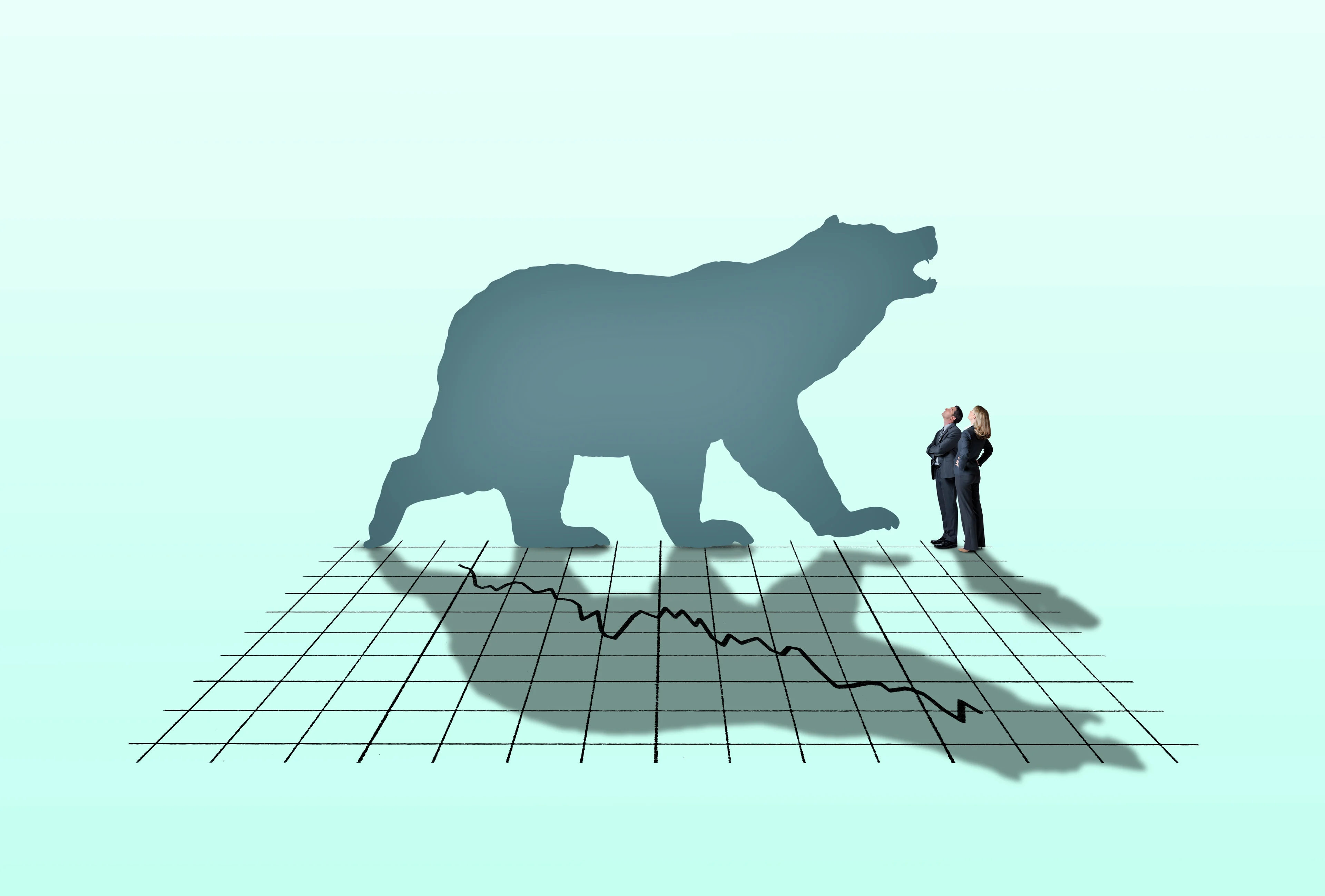 Two people looking at bear silhouette, whose shadow is falling on a downward-trending chart.