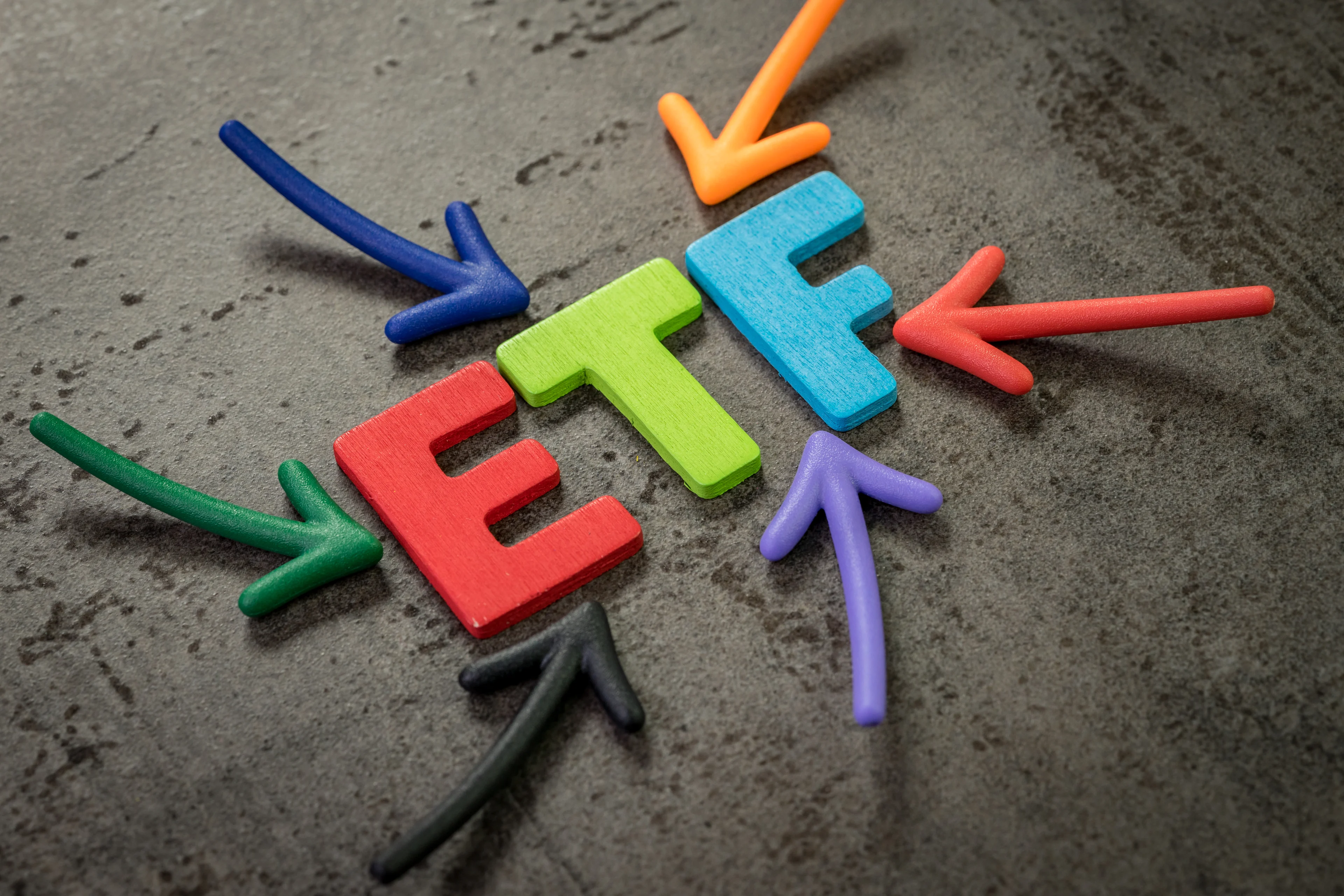 Colorful arrows pointing to letters spelling "ETF."