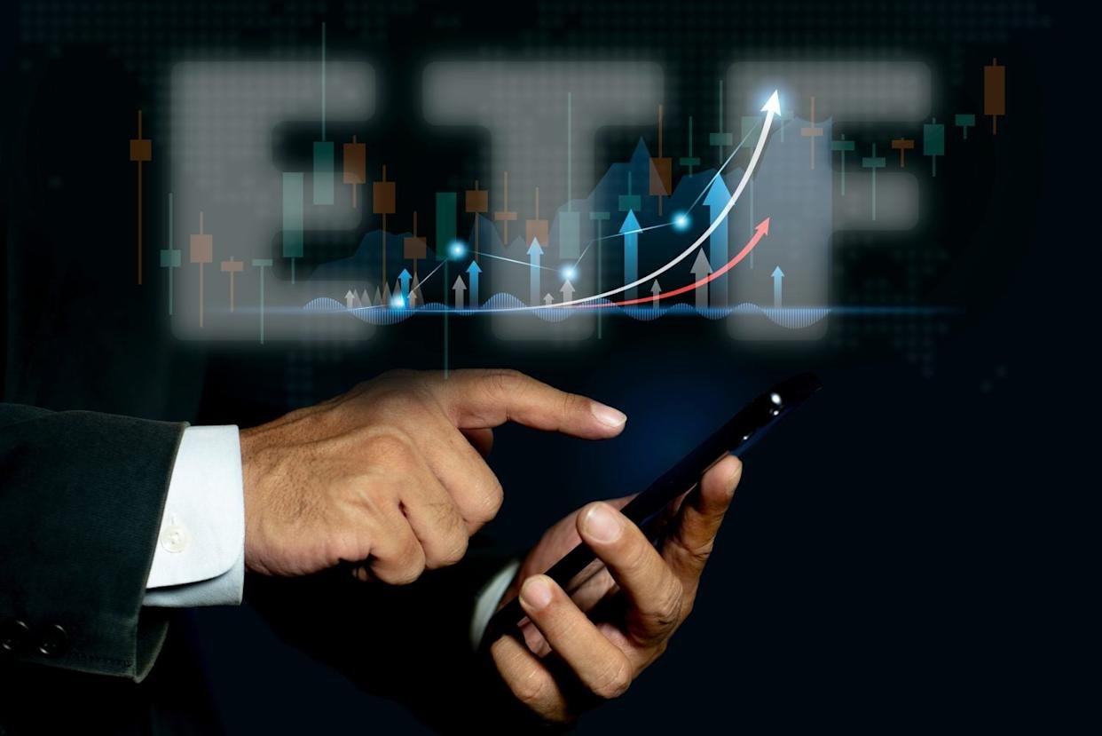 Businessman pointing at ETF (Exchange Traded Funds). Investment Opportunities in Mutual Funds and ETFs, Growing Wealth in the Financial Market.