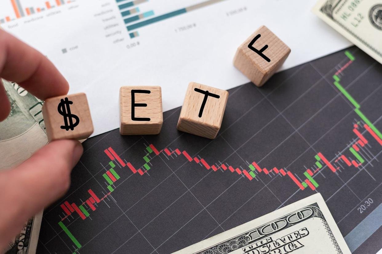 ETF exchange traded funds concept. Graph with ETF on the laptop keyboard with trade workstation app on the screen. 3d illustration