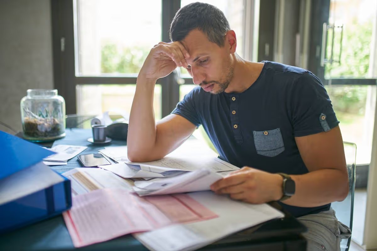 Man preparing his taxes at home
