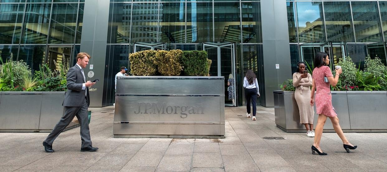 Image of a JPMorgan building with people walking in front of the signage.
