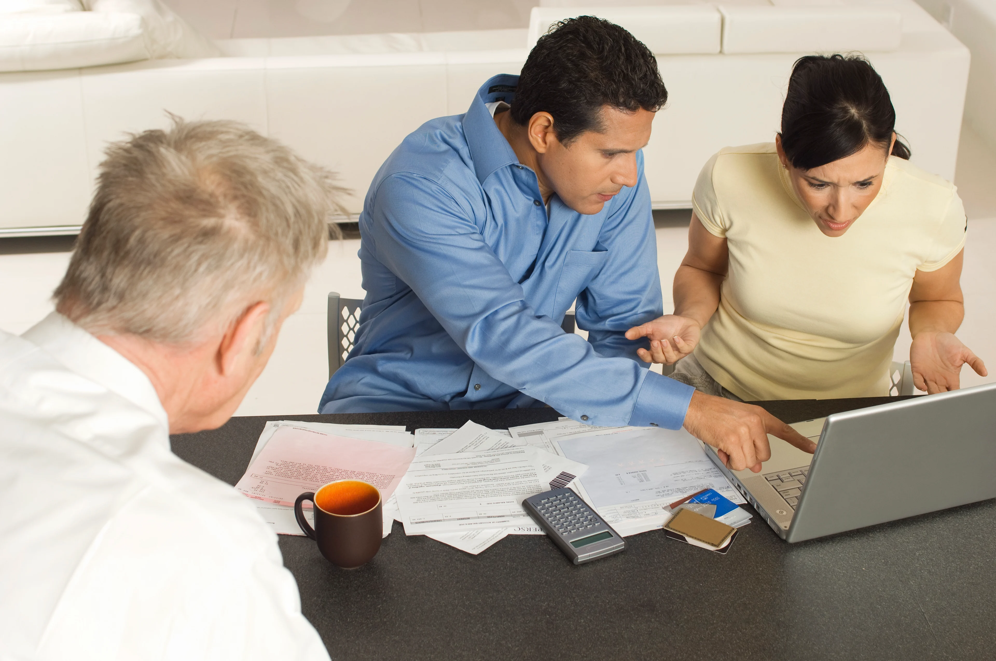 A couple reviewing financial statements with an advisor.