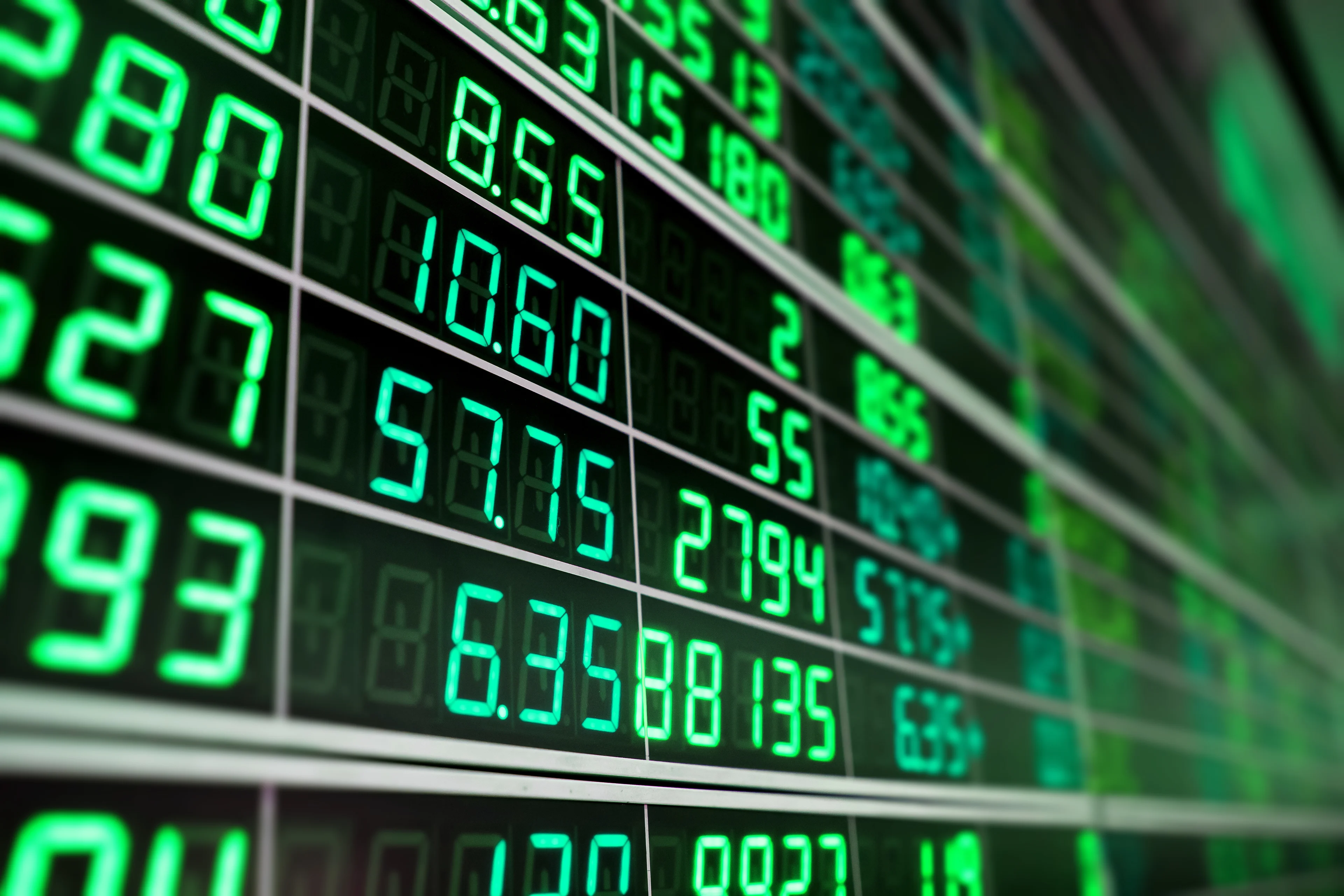 Stocks showing green on a screen.