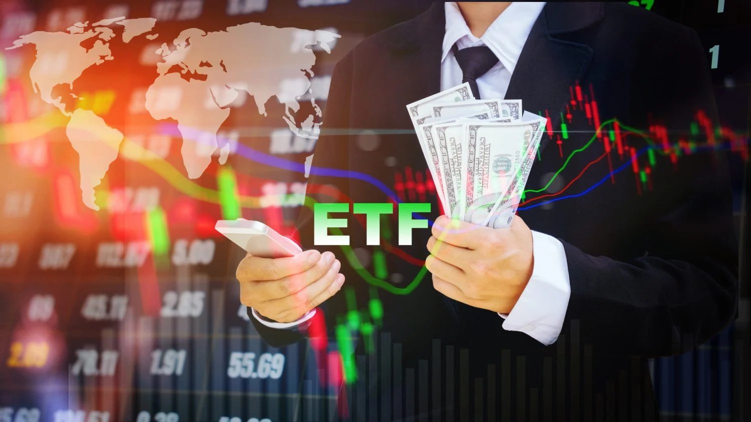 A businessman in a dark suit holds a fan of US dollar bills in one hand and a white smartphone in the other. The glowing green text 'ETF' is centered. Behind him, a blurred, dynamic financial market data screen with red and green candlestick charts, line graphs, and numerical values is visible, overlaid with a translucent white world map.