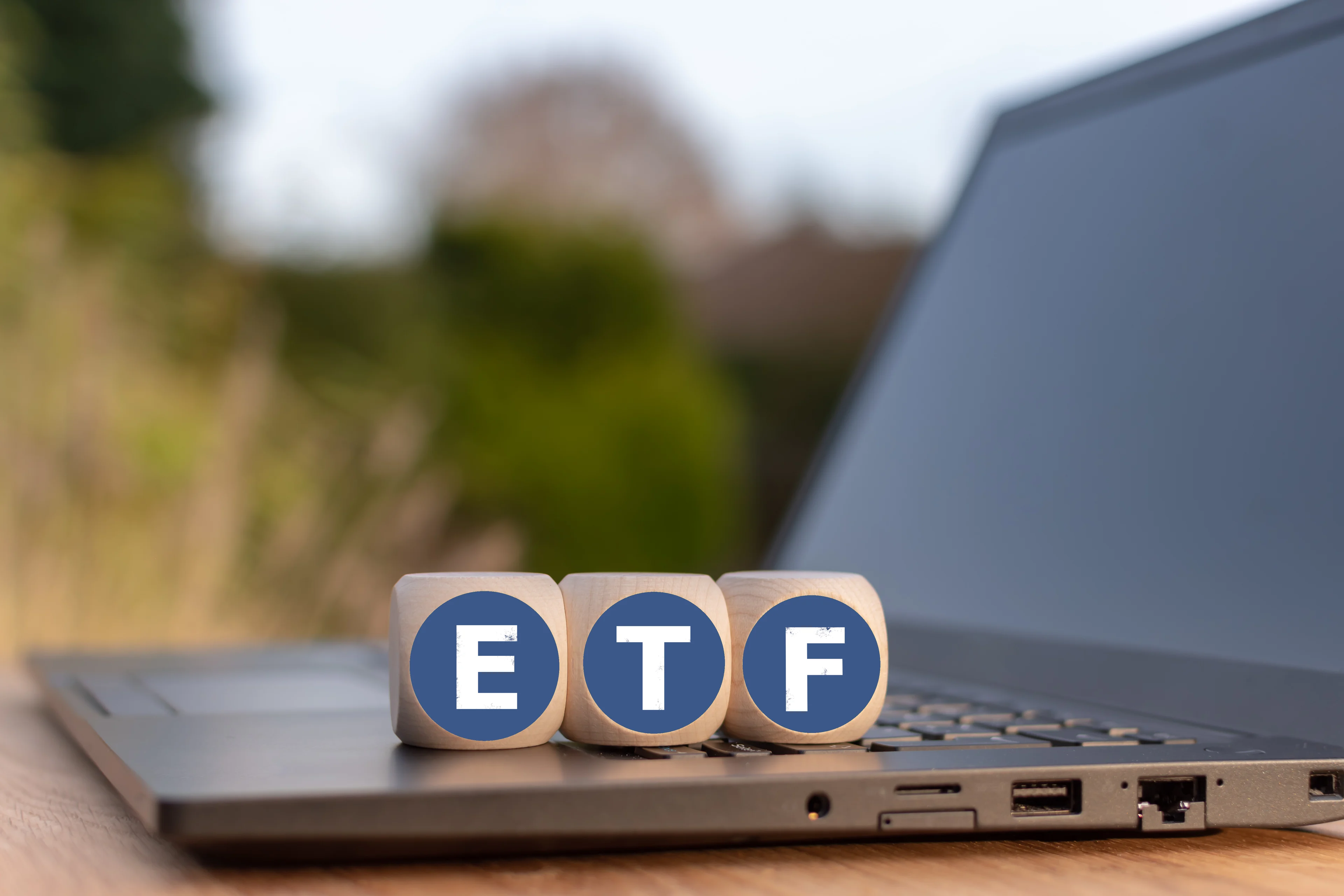 The ETF acronym on blocks sitting on a laptop.