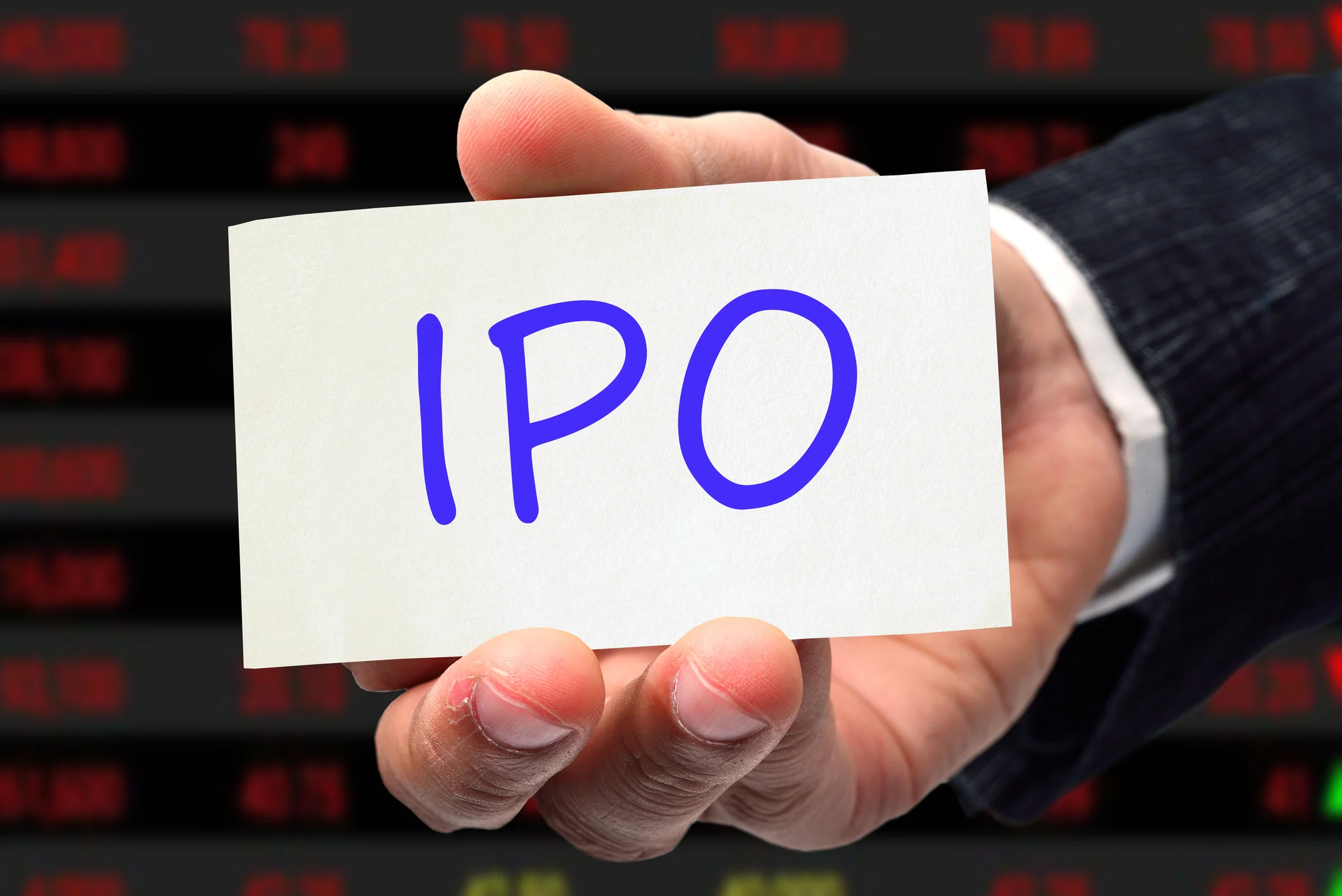A hand holding a card that says "IPO".